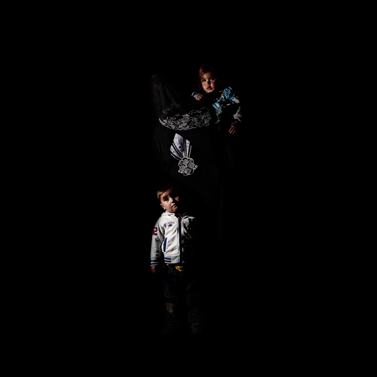Thirty-five-year-old Mariam came to Lebanon from Aleppo three years ago. Her husband doesn’t work and she has six children. Her oldest is only 12. In the portrait with her is three-year-old Ali and one-year-old Aisha. Both were born in Lebanon. Ali has a birth certificate but Aisha does not. Mariam wants to be able to register them in order to take them back to Syria when the war ends [Felipe Jacome/Al Jazeera] 
