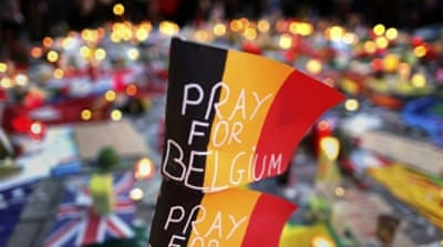 Belgian flags seen at a street memorial service near the old stock exchange in Brussels [Reuters]