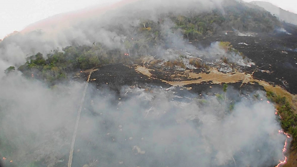 In this August 20, 2019, drone photo released by the Corpo de Bombeiros de Mato Grosso, brush fires burn in Guaranta do Norte municipality, Mato Grosso state, Brazil