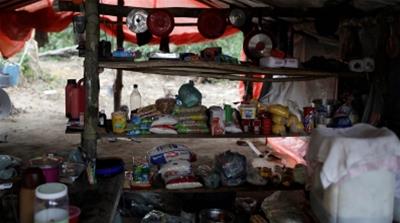 An improvised kitchen is set up at an illegal gold-mining camp