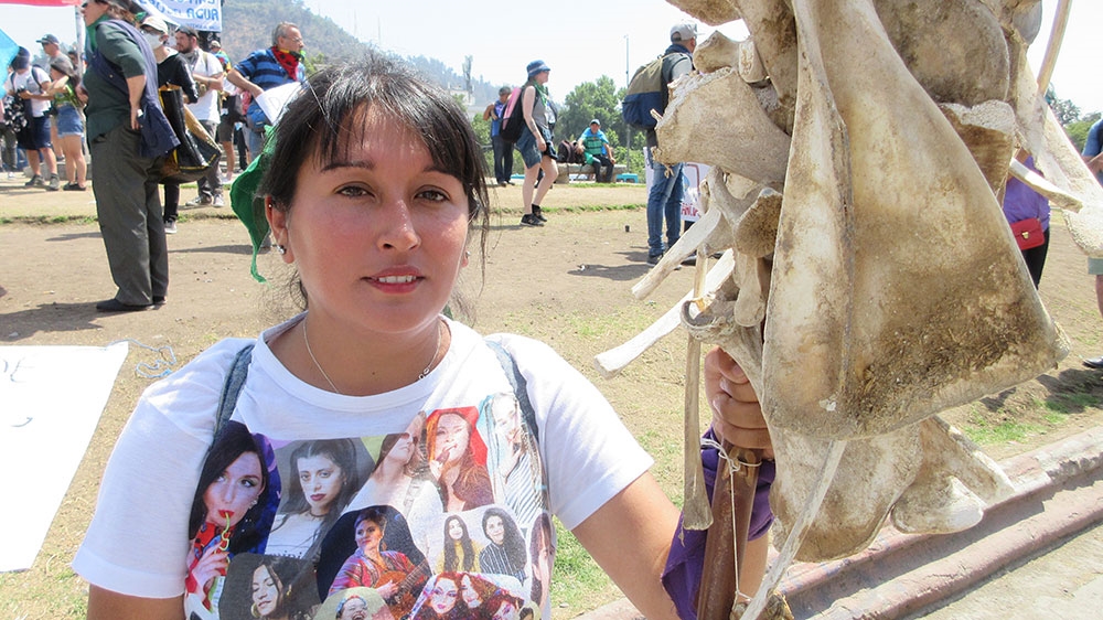 Barbara Astudillo carries bones of animals that died in the drought-stricken Petorca region of Chile