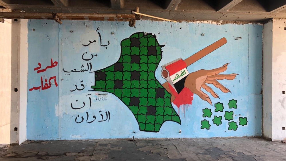 A pro-revolution mural on a wall inside a Turkish restaurant says: ‘By the people’s command, now is the time’