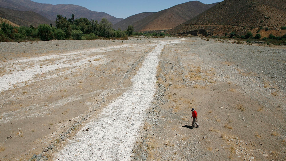 A countryman crosses a dried-up river at the Petorca town in 2008