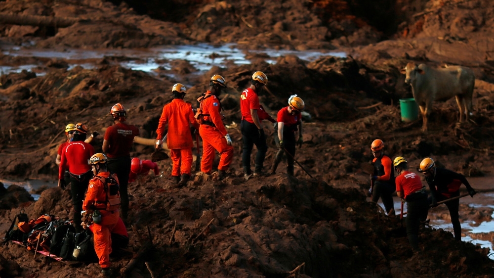 Members of a rescue team search for victims after a tailings dam owned by Brazilian mining company Vale SA collapsed in Brumadinho, Brazil in January 2019