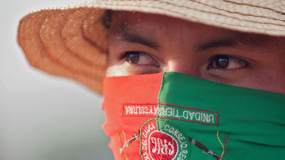 An Indigenous Guard looks on at La Maria Indigenous reserve, municipality of Piendamo, Cauca department, Colombia