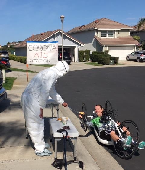 Wearing a hazmat suit, Sanden’s husband handed her oranges with a barbecue tongs during her marathon attempt outside their house in San Clemente, California [Photo courtesy: Beth Sanden]