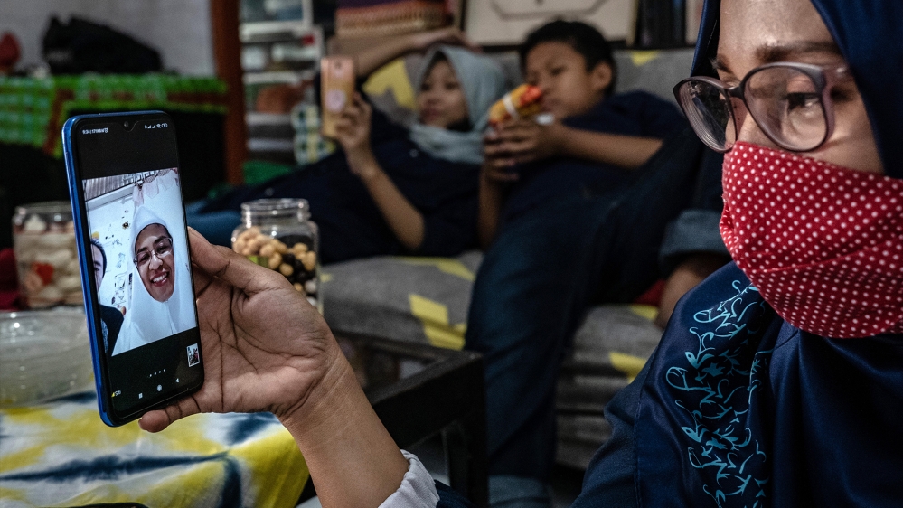 Munhari’s family members speak to each other using the Zoom app video call on Eid al-Fitr, as this year they cannot gather together to celebrate following government measures to pray and celebrate at home in Yogyakarta, Indonesia
